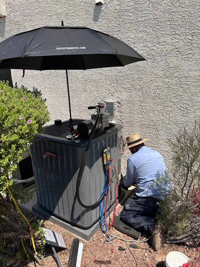 HVAC technician performing outdoor AC maintenance in East Rochester